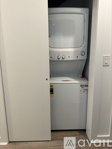 A white dryer and washer are in a small space.