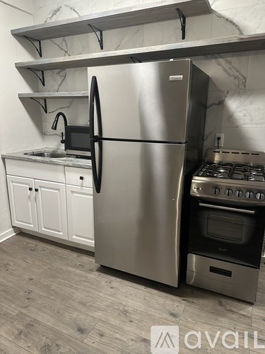 A kitchen with a stainless steel refrigerator and oven.