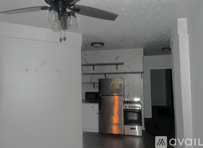 A kitchen with a stove, oven, and refrigerator.