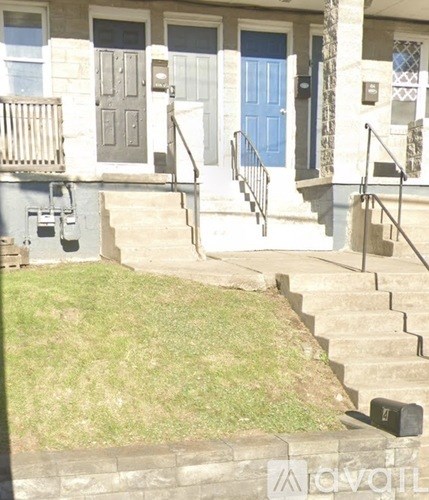 A house with a blue door and a staircase leading to it.
