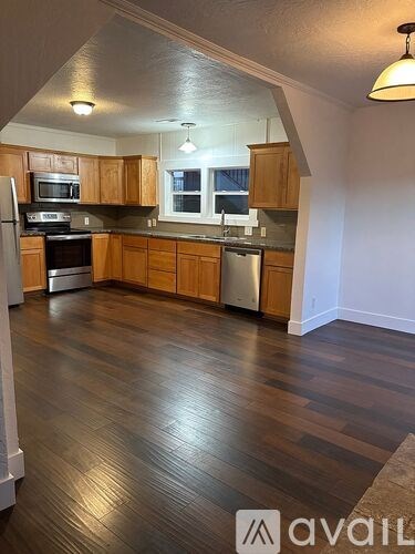 A kitchen with wooden cabinets and a refrigerator.