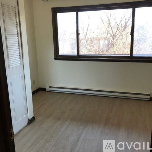 A room with a window and a door.