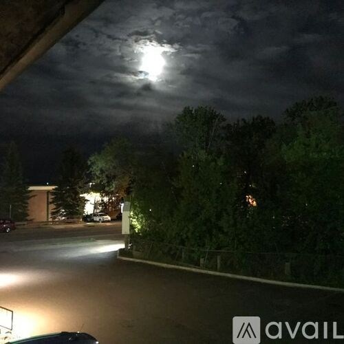 A dark sky with a full moon and clouds.