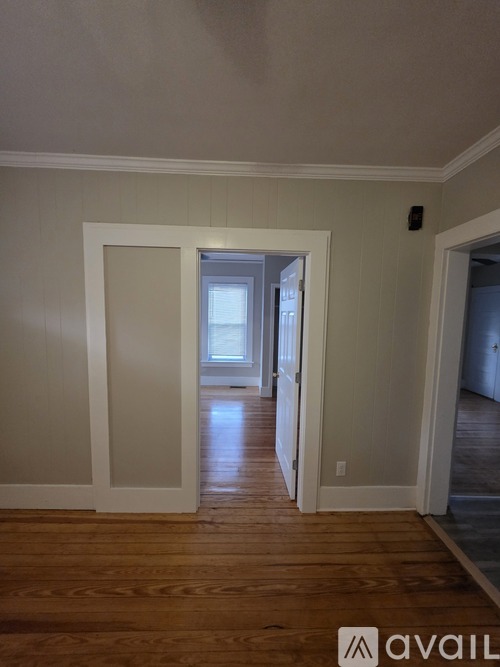 A room with wooden floors and white walls.