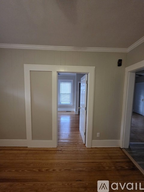 A room with wooden floors and white walls.