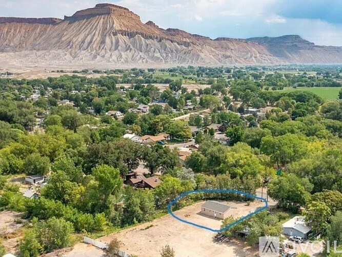 A bird's eye view of a residential area with a blue circle highlighting a specific property.
