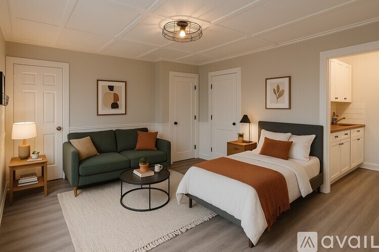 A bedroom with a bed, couch, and coffee table.