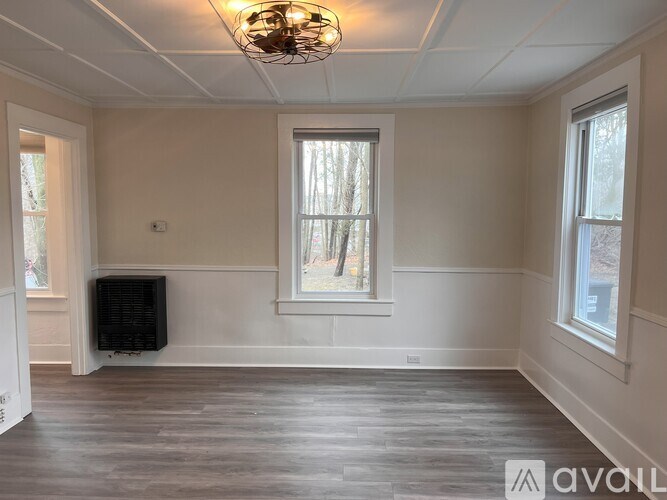 A room with a window and a radiator on the wall.