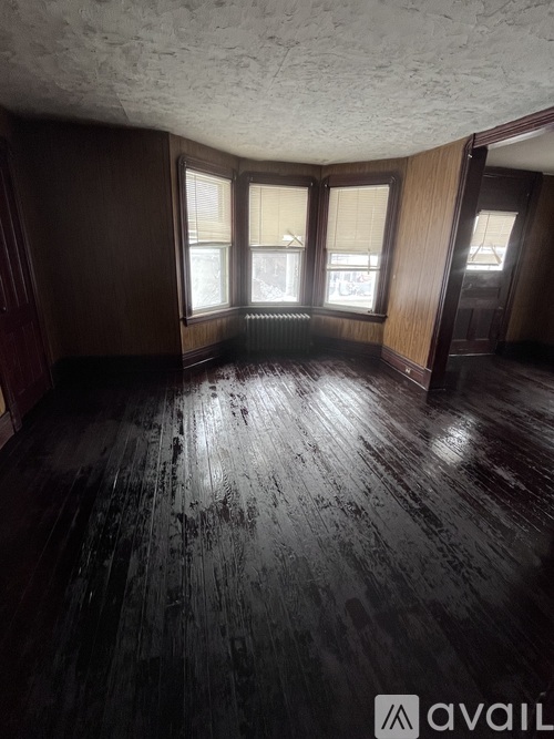 A room with wooden floors and windows.