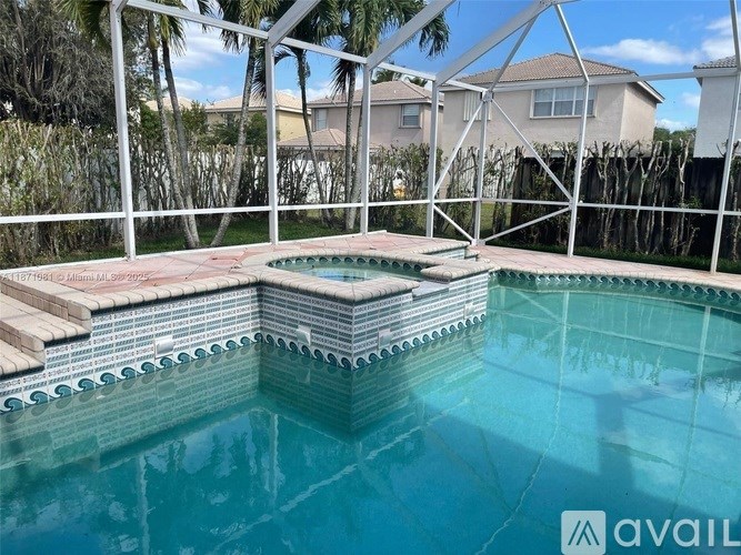 A pool with a white fence around it.