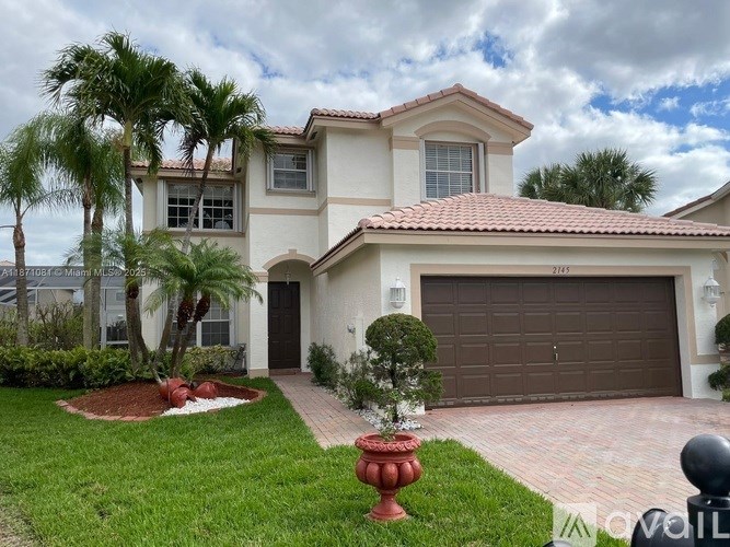 A house with a red roof and a brown garage door.