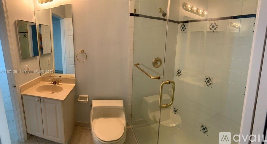 A bathroom with a toilet, sink, and shower.