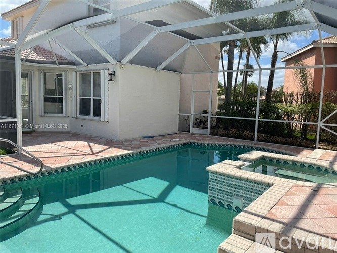 A pool with a white umbrella over it.