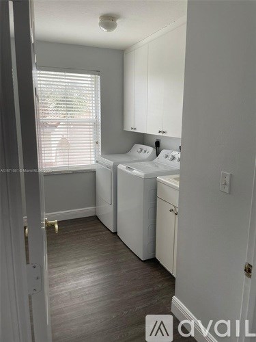 A small laundry room with a washer and dryer.