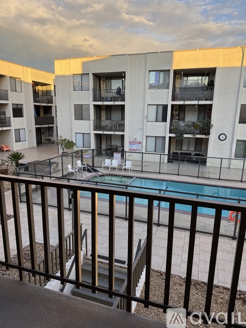 A view of a pool from a balcony of a building.