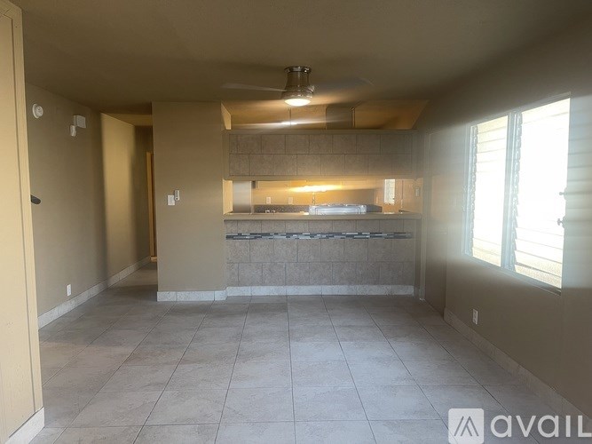 A kitchen area with a counter and a fan.