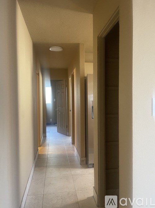 A long hallway with doors on both sides.