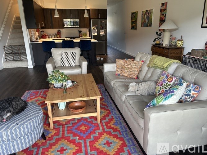 A living room with a couch, chair, and coffee table.