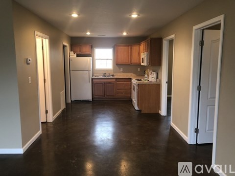 A kitchen with brown cabinets and a white fridge.