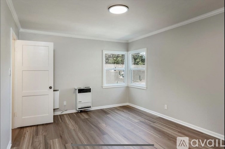 A room with a printer and a door.