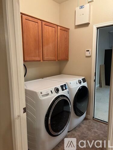 A small laundry room with a washer and dryer.