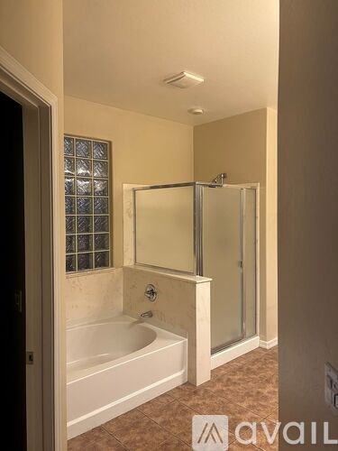 A bathroom with a tub and a walk-in shower.