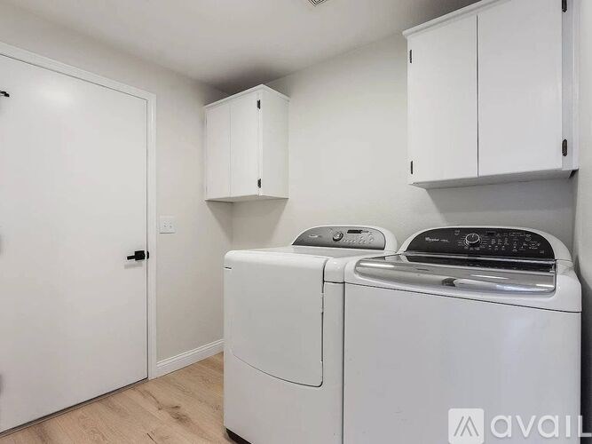 A small laundry room with a washer and dryer.