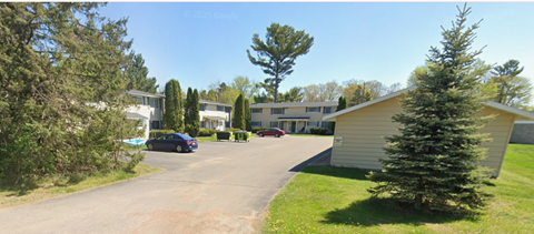 A large building with a driveway in front of it.