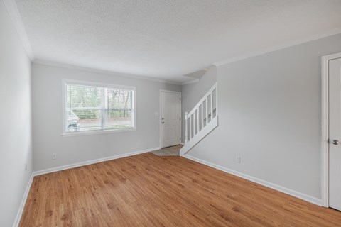 A room with wooden floors and white walls.