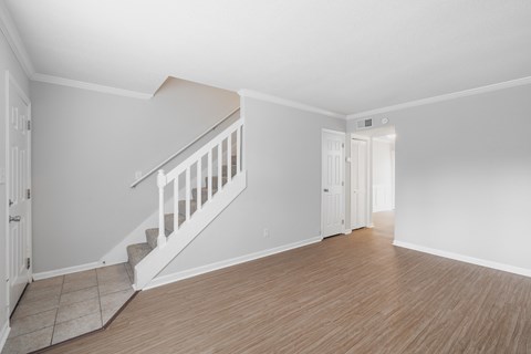 A room with a staircase and a door.