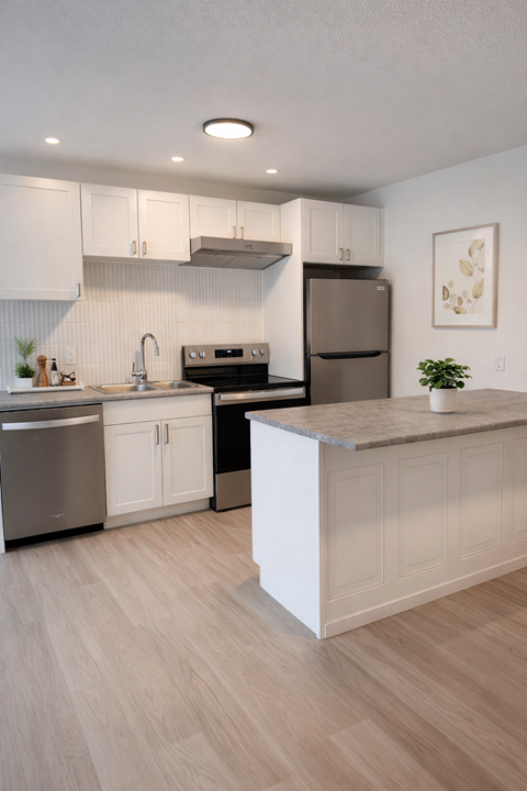 A modern kitchen with white cabinets and a wooden island.
