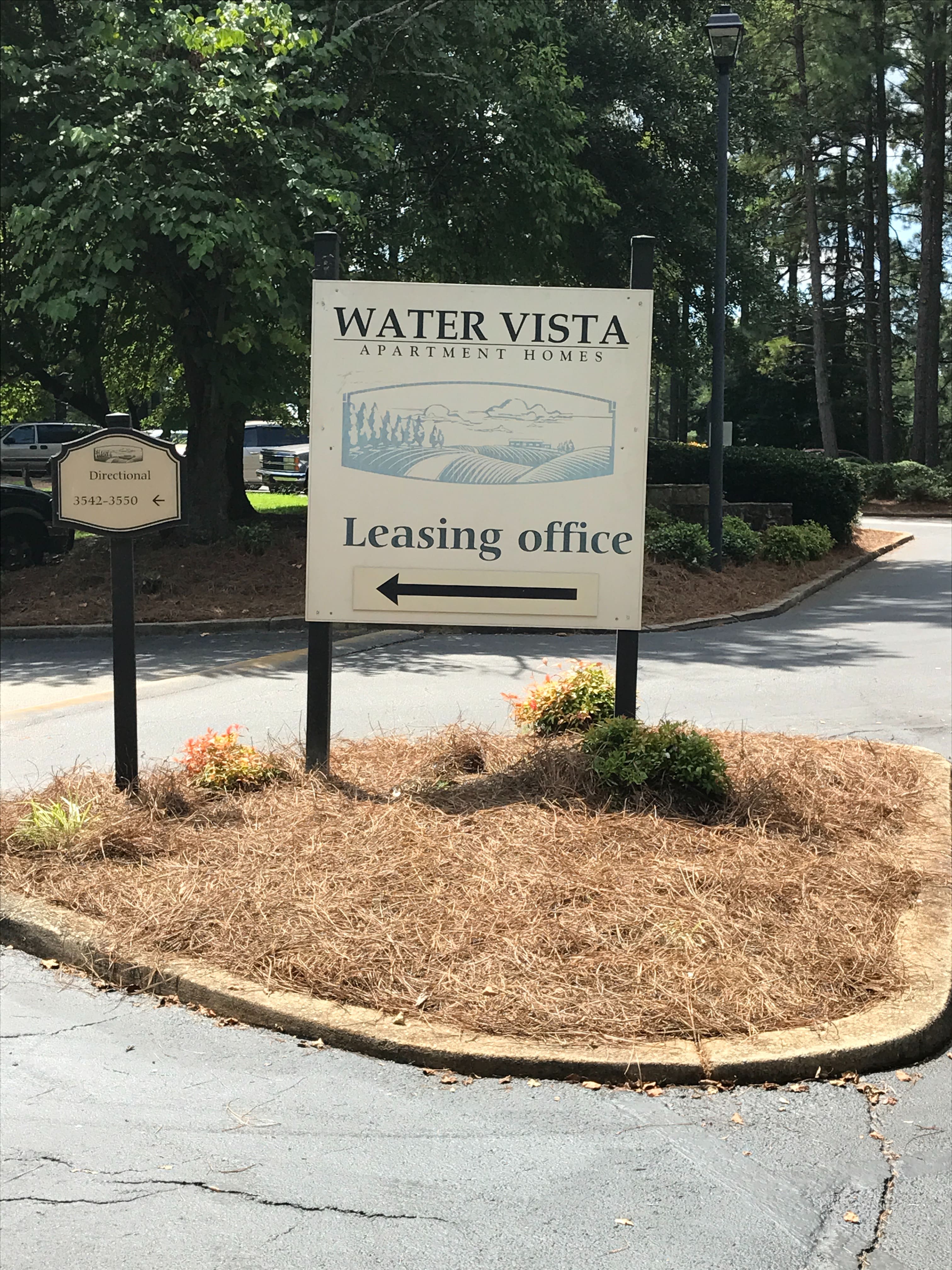 A sign for Water Vista Apartment Homes with an arrow pointing to the leasing office.