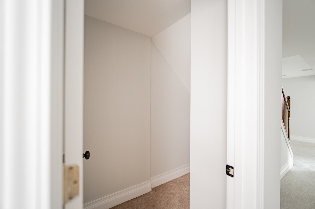 a room with a closet and a hallway with a door open