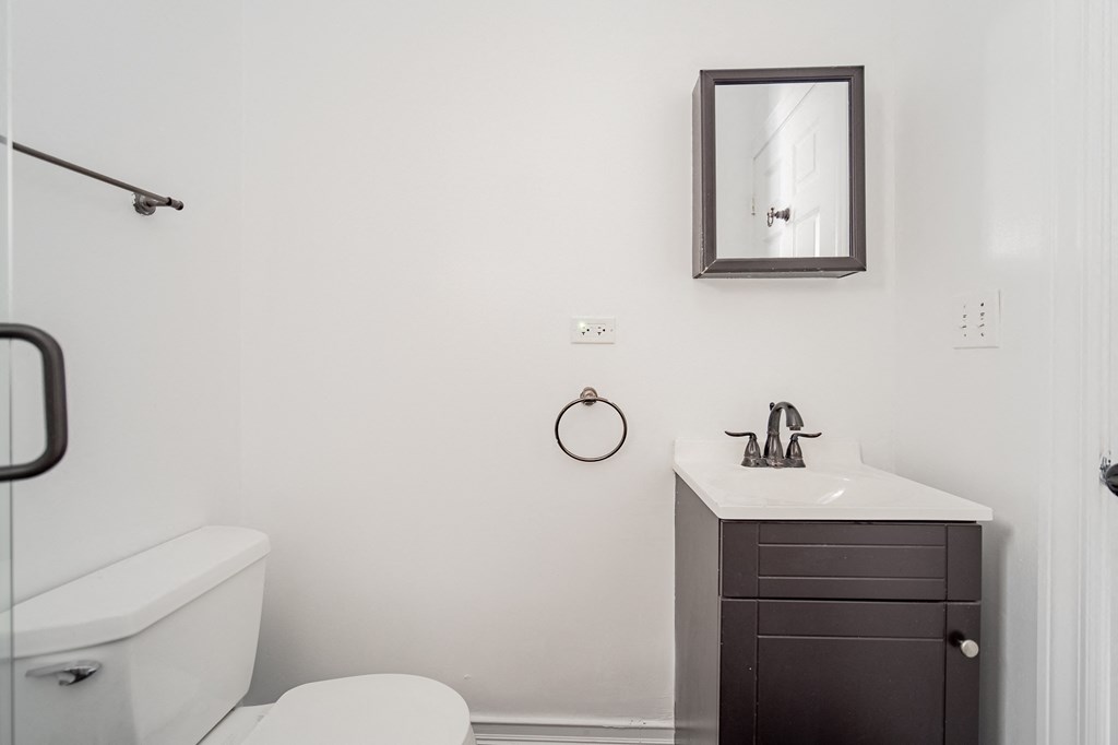 a small bathroom with a sink and toilet and a mirror
