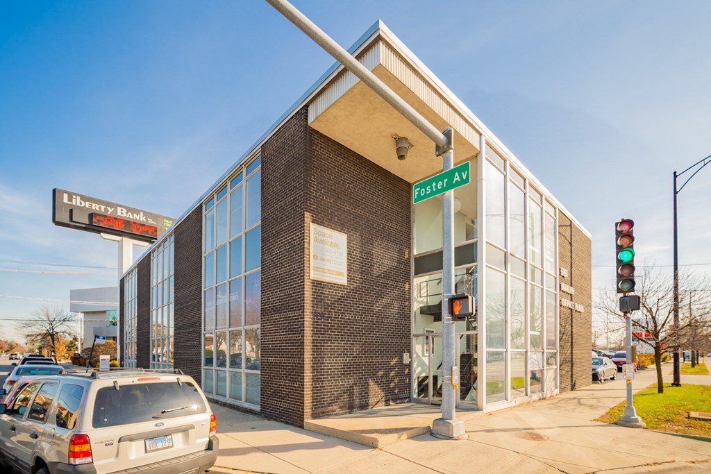 the front of a building with cars parked in front of it