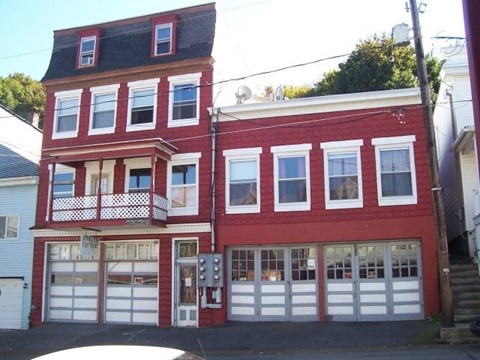 A red building with white garage doors.