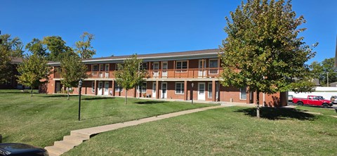 A building with a red brick exterior and a covered walkway.