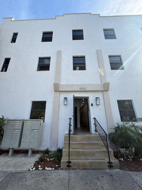 A white building with the number 1003 on the front.