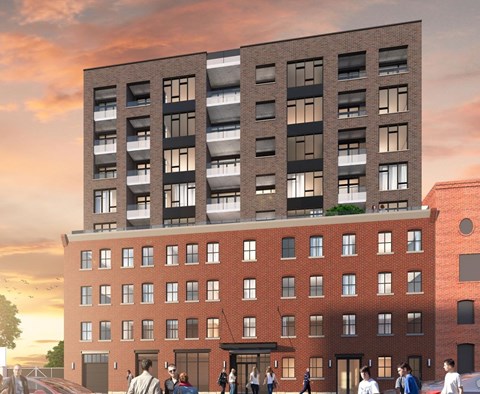 A modern building with a red brick facade and a black section on top is depicted with people walking in front.