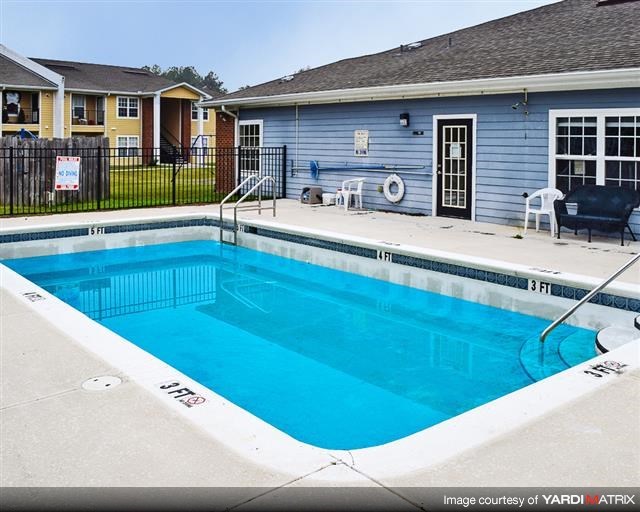 a large swimming pool in front of a house