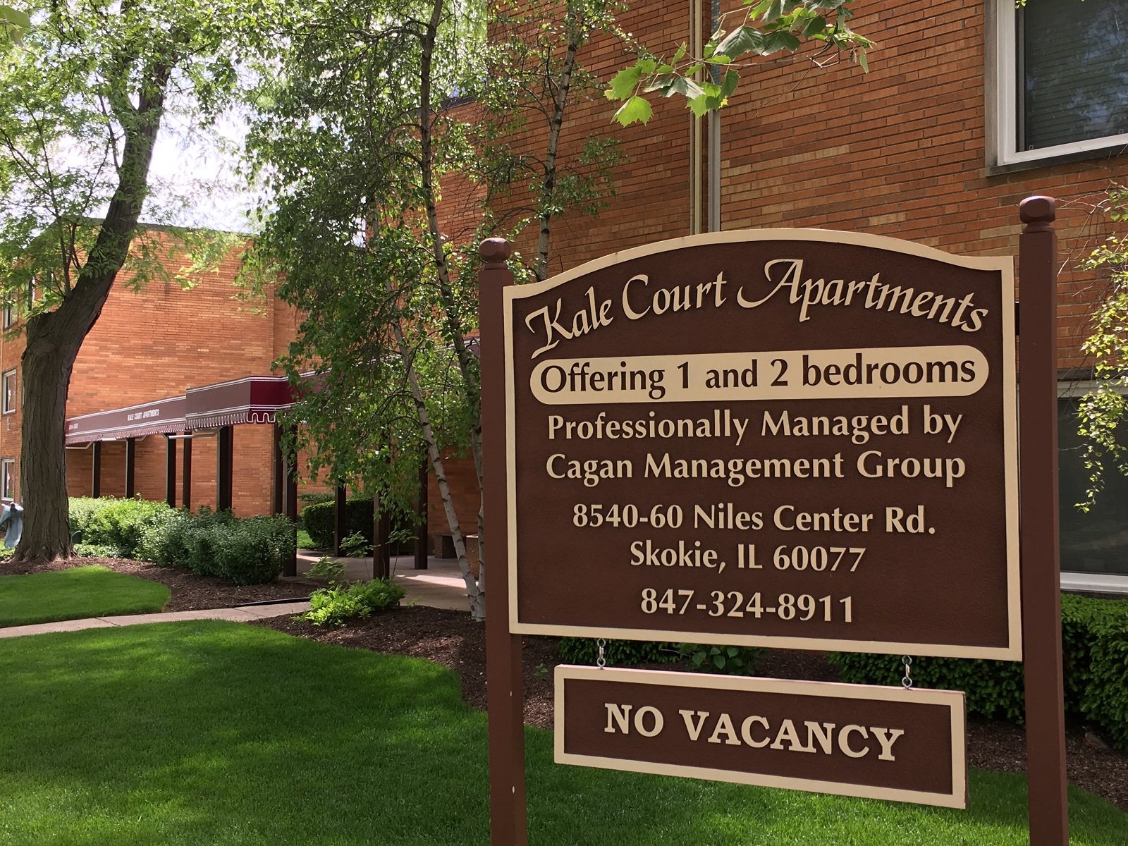 a sign in front of a brick building