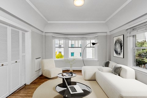 A white living room with a black and white coffee table.