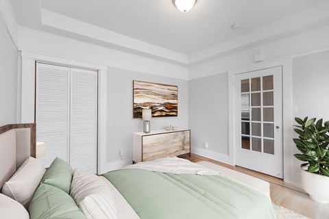 A bedroom with a bed, nightstand, and a painting on the wall.