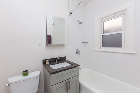 A white toilet sits next to a sink in a bathroom.
