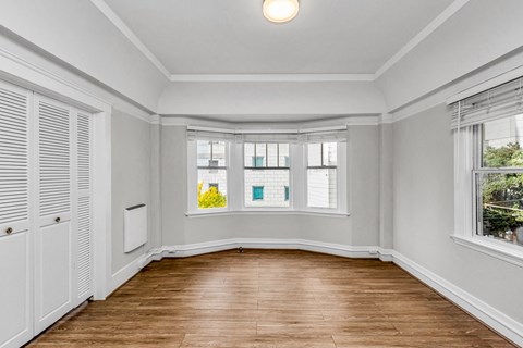 A room with wooden floors and white walls.