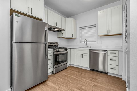 A kitchen with white cabinets and stainless steel appliances.