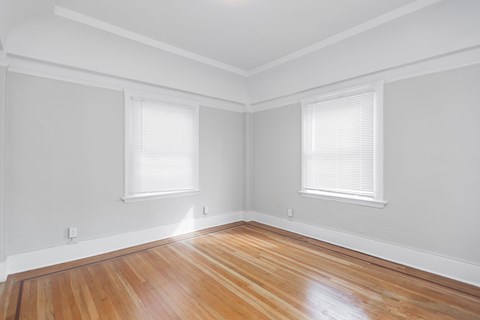 A room with wooden floors and white walls.