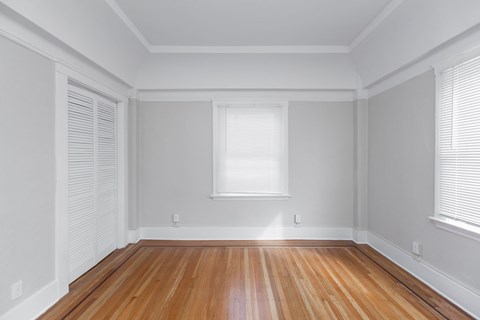 A room with wooden floors and white walls.