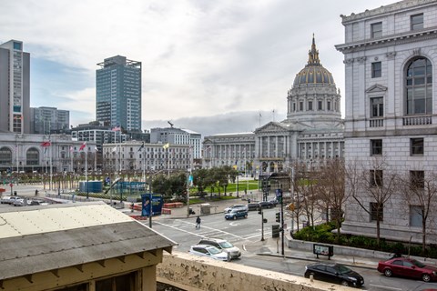 A city street with cars and buildings.