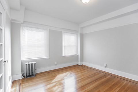 A room with wooden floors and white walls.